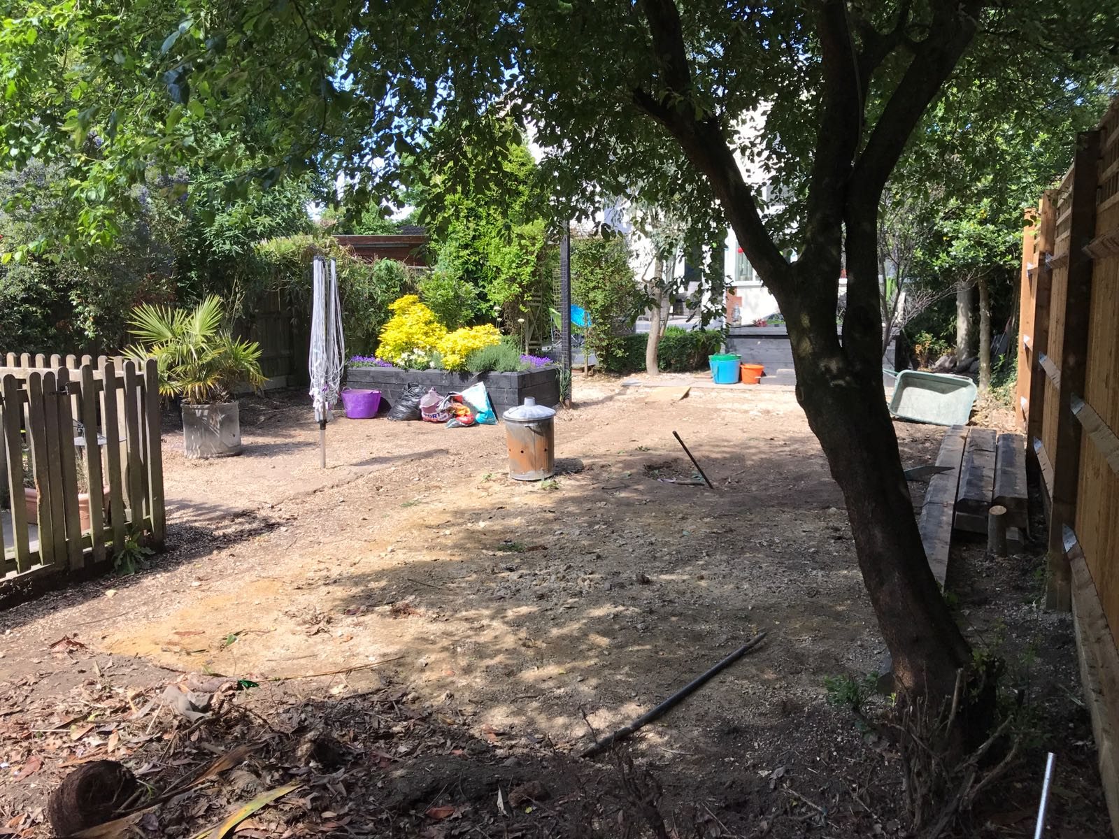 A garden stripped back to bare soil and levelled, ready for turf